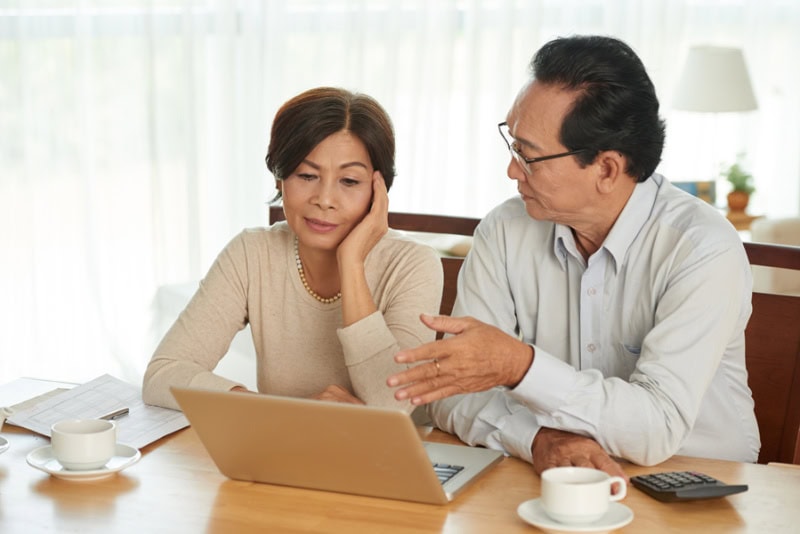 How Can I Afford a New AC System (and Other HVAC Equipment)? Photo of a couple having a discussion, seemingly unhappy.